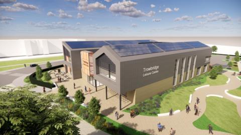 A computer generated image showing plans for the new Trowbridge Leisure Centre. It is a large building with two storeys located with green landscape around it. There are illustrations of people walking around it.