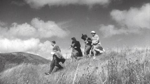 Four people walking down a hill in Aberystwyth.