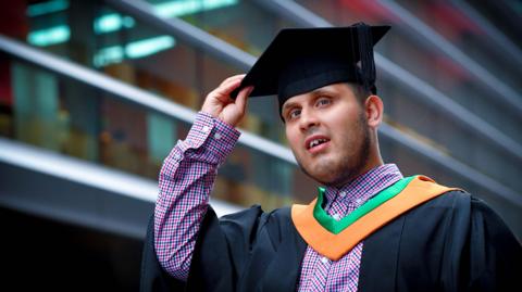 Haseeb Jabbar with a graduation gown and cap on