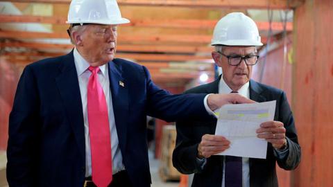 Donald Trump appears alongside Jerome Powell on a visit to the Federal Reserve building renovation.