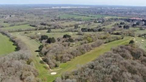 An aerial shot of woods and fields and a golf club on land west of Ifield in West Sussex, where at least 3,000 homes are planned