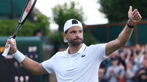 Grigor Dimitrov gives a thumb up to the crowd after winning his first-round match