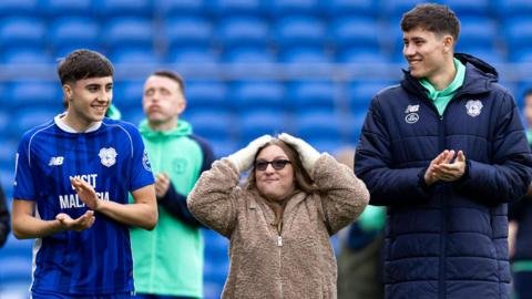 Joel Colwill (left) and Rubin Colwill (right) applaud at the end of a Cardiff game