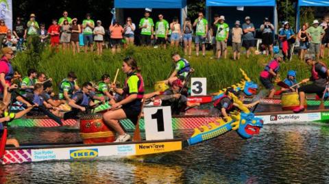 Teams racing on the water in their dragon boats