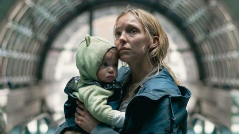 A woman holding a baby