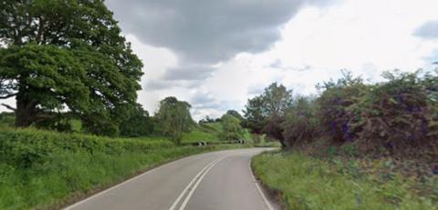 General view of a curved road in the countryside.