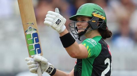Southern Brave batter Laura Wolvaardt celebrates hitting a half-century