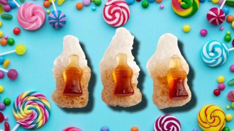 Freeze dried cola bottles surrounded by other sweets