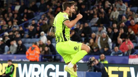 Portsmouth goalscorer John Swift leaps in the air in celebration