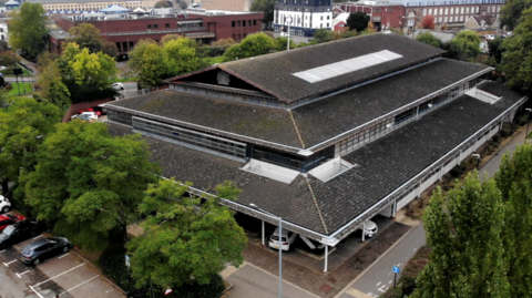 An aerial picture of Peterborough Crown Court. It has a brown, tiled roof and is three-storey.