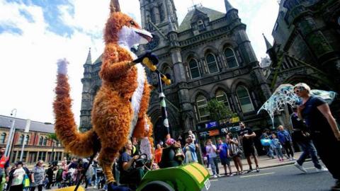 A carnival float in the shape of a fox