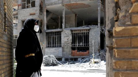 A woman looks at the rubble of her house, which was damaged in a U.S. and Israeli strike in March, in Tehran, Iran June 7, 2026