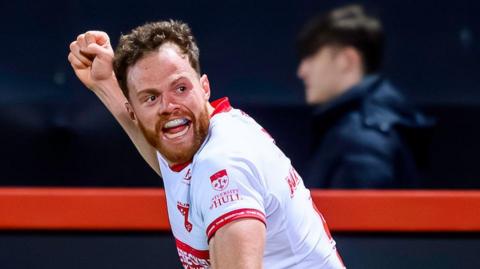 Hull KR wing Joe Burgess punching the air in delight after scoring a try.
