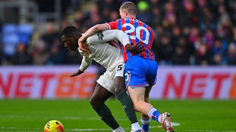 Moises Caicedo tries to hold off Adam Wharton while on the ball