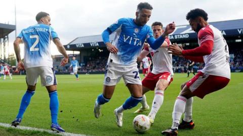 Stockport County's Odin Bailey (centre) and Stevenage's Jordan Roberts and Jordan Houghton battle for the ball