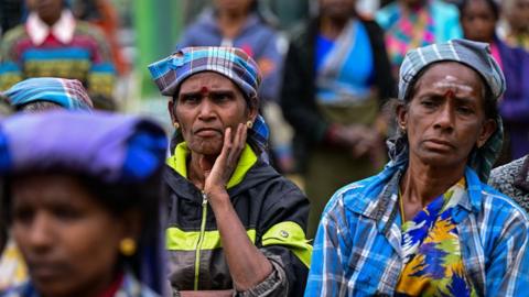 Tea pickers listen to a political speech in Sri Lanka