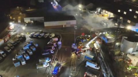 Drone footage showing a factory fire