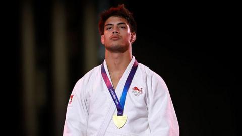 Gold medalist Ethan Nairne of Team England poses for a photo during the medal ceremony for the Men's Judo - 73 kg 