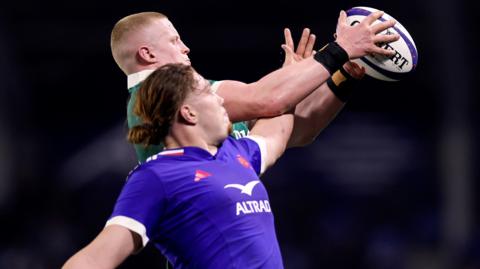 Dylan McNeice and Nils Punti challenge for the ball