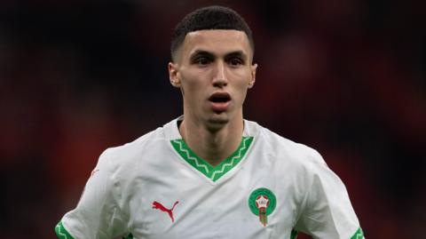 Bilal El Khannous wearing Morocco's white shirt with green trim and a red Puma logo during the Africa Cup of Nations quarter-final match with Cameroon at Prince Moulay Abdellah Stadium on 9 January 2025
