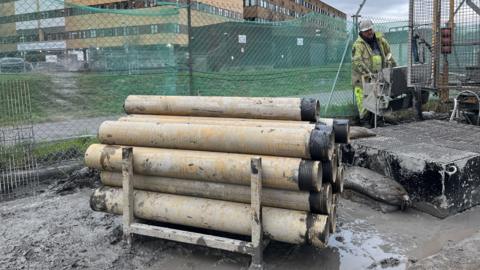 Pipes beside a borehole drill