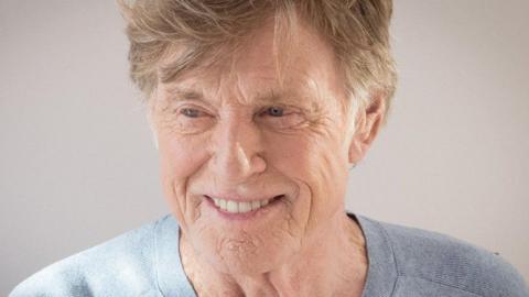 Robert Redford is seen in later life.  He is smiling and looking slightly off camera.