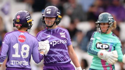Northern Superchargers batter Alice Davidson-Richards punches gloves after reaching fifty