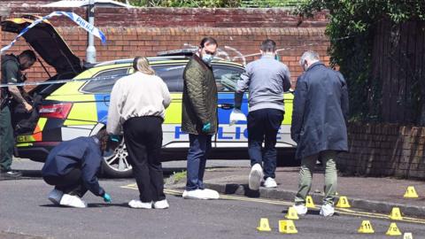 forensics and police work at the scene of a stabbing in belfast.