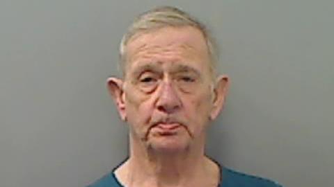 Mugshot of David McKay. He is an old man with pursed lips, clean shaven with short grey hair.