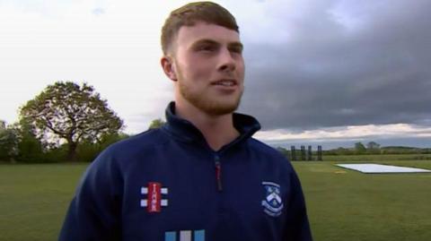 Penkridge fast bowler Myles Davis is in his club training kit standing on a cricket field