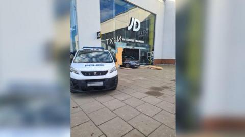 A police car outside JD Sports