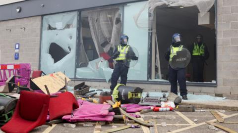 Holiday Inn Express in Rotherham, police around ruined furniture and smashed windows