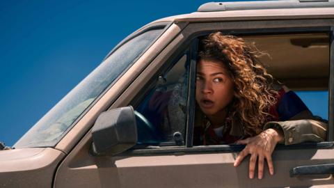 A person looking out of a car