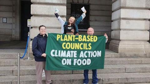 Supporters of the Plant-Based Councils campaign group celebrate with banner outside the Council House