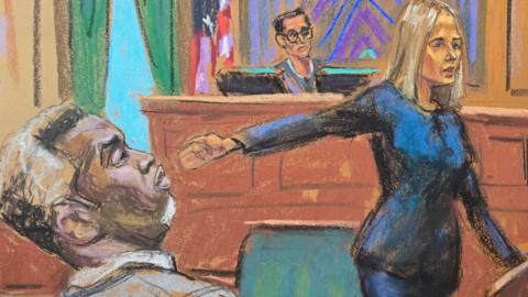 A court sketch of prosecutor Emily Johnson pointing to Sean "Diddy" Combs before U.S. District Judge Arun Subramanian at Combs' sex trafficking trial
