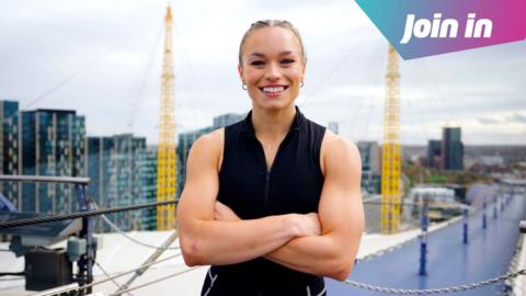 Fury smiles with folded arms at the Millenium Dome in London