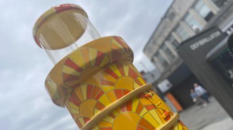 Lighthouse close up with yellow and orange sun pattern