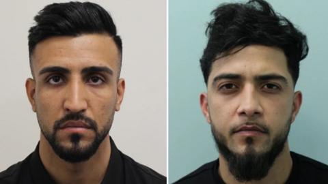 Two men feature in this police mugshot, on the left is a man with a groomed appearance with a quiff in his hair and a neat, trimmed beard and moustache. His face is solemn and serious. On the right is a man with a more dishevelled appearance, his hair is more windswept and his beard is not as neatly groomed. He has the same solemn facial expression. Both are Afghans.