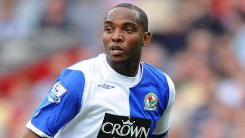 Benni McCarthy in action for Blackburn, wearing the blue and white Crown Paints home jersey, in 2008