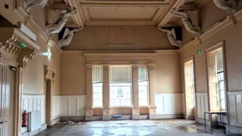 Interior of Banff town hall, with ornate ceiling.