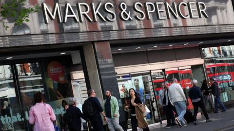 People walking past a Marks & Spencer store