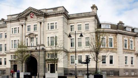 The front of Kent County Council's offices. It is a large, white, regal building.