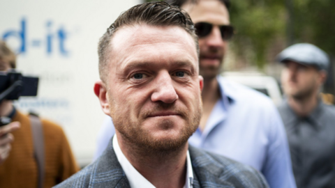 Tommy Robinson - A man wearing a suit looking into the camera