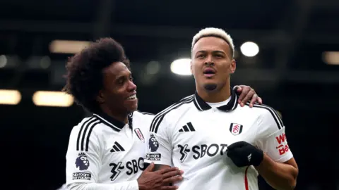 Willian and Rodrigo Muniz celebrate scoring a goal