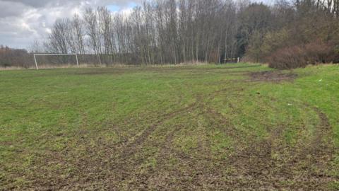 Tyre tracks from off-road bikes on a football pitch