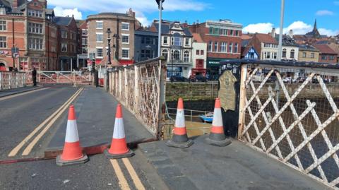 Whitby Swing Bridge is an iron structure with a single lane for traffic. With the town looking over it