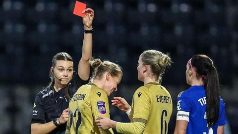 Ruesha Littlejohn is shown a red card