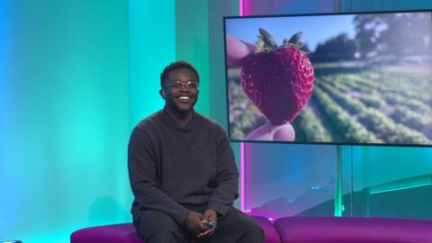 De-Graft in the studio with a strawberry in the screen
