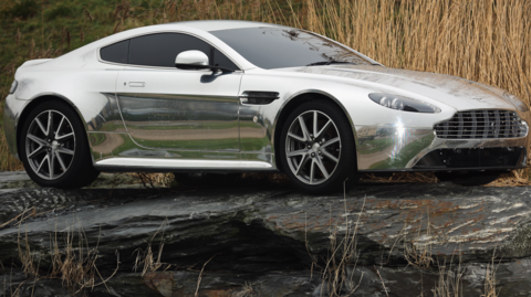 An Aston Martin motor car is displayed outside the company headquarters and production plant in Gaydon