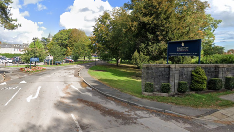 A Google Maps image of Taunton School's entrance, showing a sign and the roads into the buidling